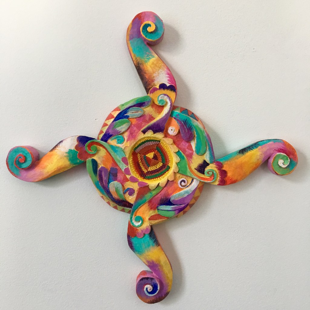 Equilateral carved wooden cross, painted and inlaid with beadwork